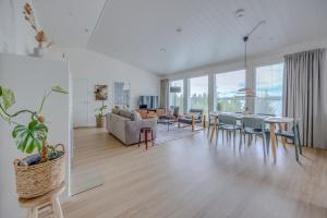 a living room with a table and chairs at Villa Vilkama 2 cabins Lake view, incl indoor hot tub, sauna in Laukaa +38 photos