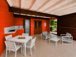 a kitchen and dining room with a table and chairs at La Baie des Villas in Deshaies