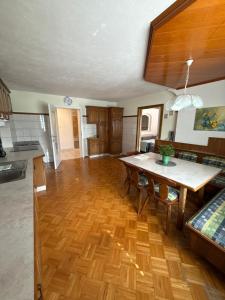 a kitchen and living room with a wooden floor at Wohnung im Grünen in Sankt Andrä