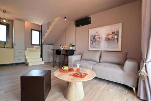 a living room with a couch and a table at Liostasi Villas by Olga in Leptokarya