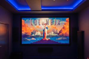 a television with a depiction of a woman on the screen at Luxury Escape with Cinema, Pool Table & Darts in Leeds