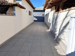a walkway between two buildings with a fence at Unamar Beach in Cabo Frio