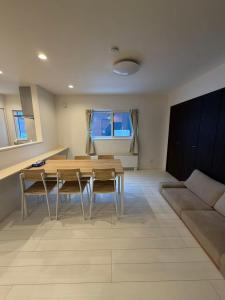 a living room with a table and chairs and a couch at 雪宿snow iin in Kutchan