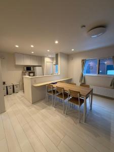 a kitchen with a table and chairs in a room at 雪宿snow iin in Kutchan