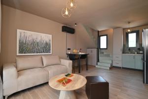 a living room with a couch and a table at Liostasi Villas by Olga in Leptokarya