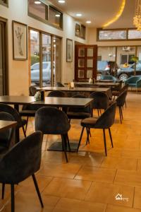 a restaurant with tables and chairs in a room at Skyblue GuestHouse in Lubumbashi