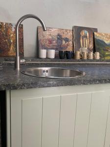 a kitchen counter with a sink and a painting at Casa la meridiana in Laigueglia +52 photos