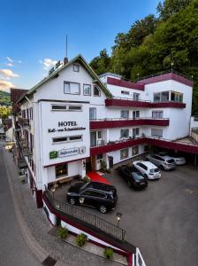 a hotel with cars parked in a parking lot at Hotel Kull von Schmidsfelden in Bad Herrenalb