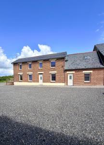 a large brick building with a lot of windows at Gite Maison Saint-Martin in La Groise