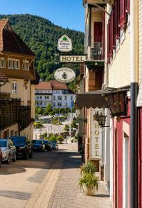 a street in a small town with cars parked on the street at Hotel Kull von Schmidsfelden in Bad Herrenalb