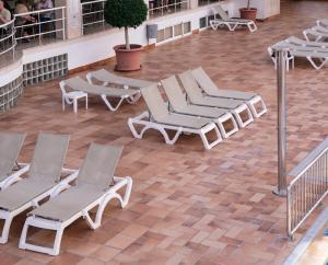 a group of lounge chairs on a patio at Port Fiesta Park in Benidorm
