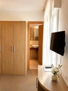 a room with a desk with a television on it at HOTEL TRIESTE in Riccione