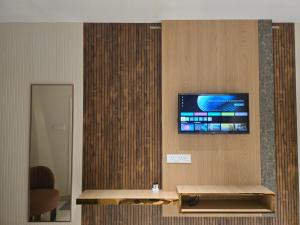a flat screen tv on a wall in a lobby at Hotel Royal Akkamahadevi in Sundi Penta