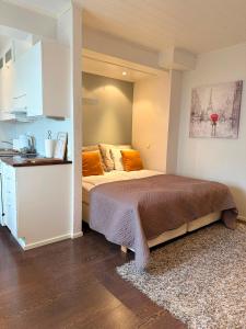 a bedroom with a large bed and a kitchen at KODA Walk Everywhere in Rovaniemi