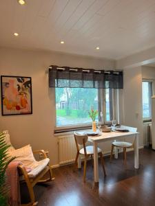 a dining room with a table and chairs and a window at KODA Walk Everywhere in Rovaniemi