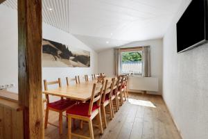 a dining room with a wooden table and chairs at Ferienhaus Anton in Gerlosberg