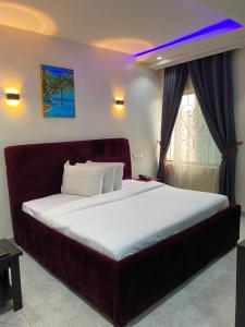 a bedroom with a large bed in a room at S&B Hotel in Agege