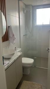 a bathroom with a toilet and a sink and a shower at Gaudi in Santa Cruz do Sul +16 photos