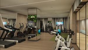 a gym with treadmills and elliptical machines at Novotel Bhubaneswar Janpath in Bhubaneshwar