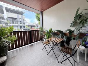 a balcony with a table and chairs and plants at the 19Th Transient House in Solano