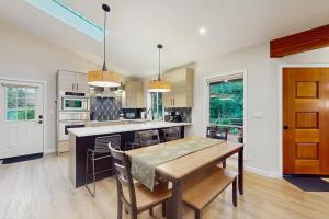 a kitchen with a table and chairs and a dining room at Sanctuary on Park Ave in Hawley