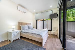 a bedroom with a bed and a large window at Casa Mediterraneo in Carpintero +13 photos