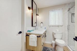 a bathroom with a toilet and a sink and a shower at Sanctuary on Park Ave in Hawley +9 photos
