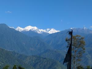a view of a mountain range with snow covered mountains at Mochilero Homestead in Pelling