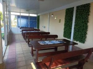 a row of tables and benches in a restaurant at Sunny House in Kranevo +37 photos