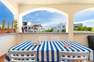 a table with a blue and white striped table cloth at Sa Omu Bianca in Tortolì