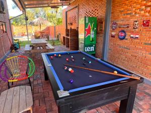 a pool table with balls on it in a patio at Cabaña Premium Yvyja de La Mala Junta in Atyrá