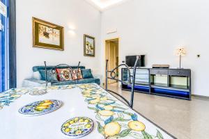 a living room with a bed and a couch at Al Portico in Avola