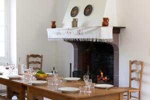 a dining room with a table and a fireplace at Gîte Zelai Begi in Aldudes