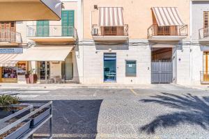 a building with balconies on the side of a street at Al Portico in Avola