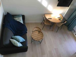a living room with a couch and a table at Barbotinecures vacations in Barbotan-les-Thermes