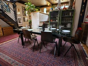 a dining room with a black table and chairs at Villa Georges in Issy-les-Moulineaux +25 photos