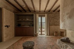 a living room with a large window and a table at Eunoia Suites in Krotiri
