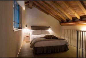 a bedroom with a large bed in a room at Locanda Cà dei Santi in Induno Olona