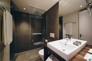 a bathroom with a sink and a shower and a toilet at Hôtel des Voyageurs Boutique in Lausanne +88 photos