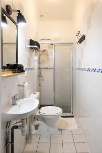 a bathroom with a toilet and a sink and a shower at Gîte Zelai Begi in Aldudes +20 photos