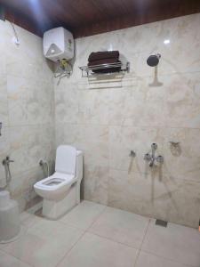 a bathroom with a toilet and a shower stall at Hotel Royal Akkamahadevi in Sundi Penta