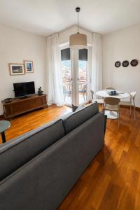 a living room with a couch and a table at Verde Acqua two Apartments in Lecco