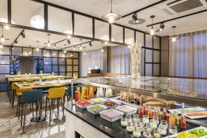 a restaurant with a buffet line with food at NH Hamburg Altona in Hamburg