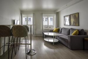 a living room with a couch and a table at Magic Kloverhuset Harbour Hotel, a member of Radisson Individuals in Bergen