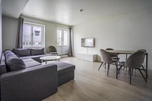 a living room with a couch and a table at Magic Kloverhuset Harbour Hotel, a member of Radisson Individuals in Bergen
