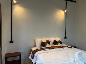 a bedroom with a bed with lights on the wall at Mountainblues Hotel in Pai
