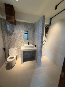 a bathroom with a toilet and a sink at Mountainblues Hotel in Pai +48 photos