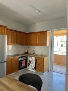eine Küche mit Holzschränken und einem Kühlschrank in der Unterkunft Brillarooms in Rethymno