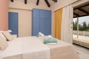 a bedroom with two beds and blue cabinets at Sunrise Stone Villa in Agios Nikolaos