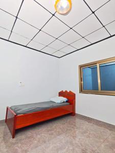 a bedroom with a bed and a mirror on the ceiling at Keitaya Dubreka Guinea in Conakry +6 photos